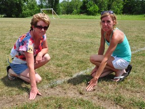 Havelock and District Soccer Club secretary Wendy Cassidy and president Bev Flagler point to some of the ruts made by ATVS on the Havelock soccer field south of Highway 7.