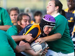 Bow Valley Grizzlies Cochrane’s player Mikayla Andrews carries the ball and a few players during their game against the Fighting Irish, July 17.