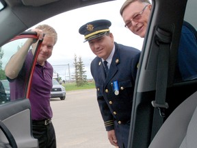 Sean Sargent (left) goes over some of the different features of the brand new 2013 Toyota Rav4 with County Fire Services Fire Marshal Ken Atamanchuk and Grande Prairie and District Burn Society past president Mark Whelpton when the vehicle was donated on Tuesday. (Jocelyn Turner/Daily Herald-Tribune)
