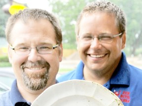 Divers Chris Bell and Aaron Breimer show off the 1851 fully intact plate from E.B. & S. Ward Steamer line. Bell discovered the 162-year-old plate while drift diving in the St. Clair River on July 21. Diana Martin/Chatham Daily News/QMI Agency