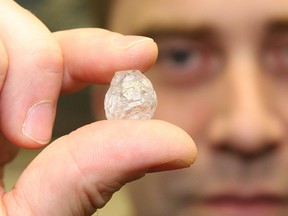 In this file photo, Dylan Dix, of Crossworks Manufacturing in Sudbury, ON., holds a 35.8 carat diamond. JOHN LAPPA/THE SUDBURY STAR/QMI AGENCY