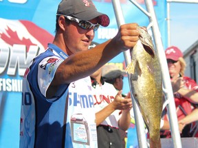 Kingston Canadian Open of Fishing champion Cory Johnston, of Peterborough, displays one of the bass he caught during a strong final day in the three-day tournament last year. Johnston also won the event in 2011. (Whig-Standard file photo)