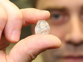 Dylan Dix, of Crossworks Manufacturing in Sudbury, holds a 35.8 carat diamond.