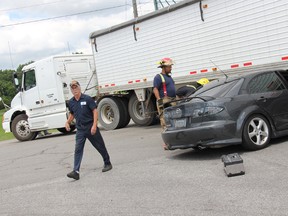 A man has been taken to hospital after a collision with a transport truck that embedded the front of his car under the truck’s trailer. KIRK DICKINSON/FOR CHATHAM DAILY NEWS/ QMI AGENCY
