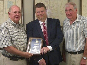 Volunteer Steve Kucera, left, receives a plaque from Lambton County Warden Todd Case and Brooke-Alvinston Mayor Don McGugan. Kucera, who is a longtime Alvinston Rotarian, was named July's Warden's Citizen of the Month. SUBMITTED PHOTO / THE OBSERVER / QMI AGENCY
