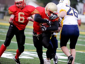 Sarnia Imperial running back Julian Shadd-Gentry, centre, gets facemasked on a run against the Sault Ste. Marie Steelers during a Northern Football Conference game on Saturday at Norm Perry Park in Sarnia. LIZ BERNIE/THE OBSERVER/QMI AGENCY