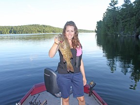 Ashley Rae holds a smallmouth bass caught and released on Palmerston Lake. (Supplied photo)