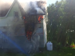 Flames poke through a house on Waddell Road in South Dundas on Wednesday. Submitted photo from South Dundas Fire Department