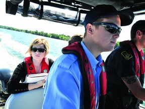 Recorder and Times reporter Alanah Duffy tags along with the Leeds County OPP marine unit on Thursday. At right is OPP officer Joel Stone and marine unit summer student Kyle Greene (THOMAS LEE/The Recorder and Times).