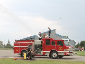 Potential firefighters get a chance to see the Pump Truck 4 in action during a recruitment information evening at the Wetaskiwin Fire Hall July 18.