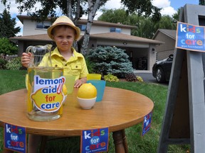 Isaac Whalen sits at his lemonade stand in Belleville on Thursday. Whalen is one of about 12 local youngsters already registered as a summer fundraisers for the Belleville General Hospital Foundation. The program is currently accepting participants.