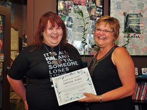 Sabrina Kuhn (left) is handed a certificate by Jo-Ann Bérubé naming her July’s Chantal Bérubé Youth of the Month. (Omar Mosleh/La Nouvelle Beaumont News)