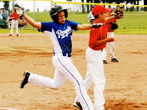 Hustle like this helped the peewee Royals to a silver medal as this base runner just beats the throw to first in championship game action. - Gord Montgomery, Reporter/Examiner