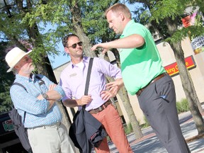 Carson Warrener, operations manager for the Downtown Chatham Centre, right, takes Communities in Bloom judges Bob Ivison, left, and Alain Cappelle, centre, on a tour of downtown Chatham. The judges, who hail from Belgium and the U.K., will be in Chatham-Kent from July 25-28 as part of the Communities in Bloom international competition. KIRK DICKINSON/FOR CHATHAM DAILY NEWS/ QMI AGENCY