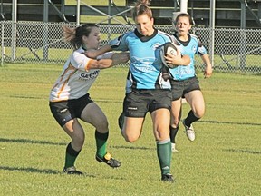 A straight-arm to fend off a tackle proved to be successful for this member of the U19 women’s Sharks rugby team, as they ran to a convincing 40-10 win over the Leprechaun/Tigers in their latest league game. The win moved the Sharks record to 4-0 on the season. - Gord Montgomery, Reporter/Examiner