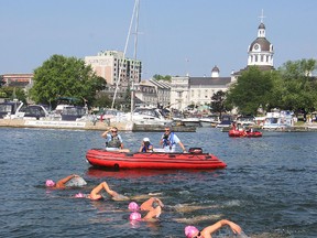 Accompanied by a support boat, Mona Sharari, left, Samantha Whiteside, Colleen Shields, Nicole Mallette and Rebekah Boscariol swim out of Confederation Basin Tuesday morning to begin their five-day swim from Kingston to Burlington.
Michael Lea The Whig-Standard