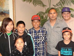 Randy Anderson (second from top right) stands with several of the kids living at Misty Lake Lodge since being evacuated from their community during the flood of 2011. Anderson said alleges certain flood co-ordinators have done drugs in the hotel, making it unsafe for the kids who live there. (JOYANNE PURSAGA/Winnipeg Sun)