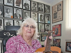 Marilynne Caswell holds a guitar signed by legendary country star  Hank Snow. (Brian Thompson, The Expositor)