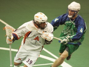 Six Nations Arrows' Josh Johnson keeps the ball away from Peterborough Jr Lakers Jake Withers Thursday during Game 3 of their best-of-seven Ontario Junior A Lacrosse League semifinal at the Iroquois Lacrosse Arena. (DARRYL G. SMART, The Expositor)