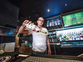 Drew Watling of the Fountainhead Pub in Vancouver’s West End pours out a bottle of Russian vodka. The pub is no longer serving Russian spirits in light of Moscow’s recent passing of laws that activists say discriminate against the LGBTTQ community. (CARMINE MARINELLI, 24 HOURS)