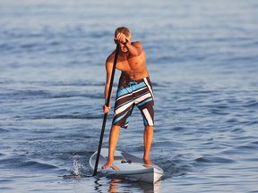 Stand up paddling is gaining popularity among fitness enthusiasts. (australia.com)