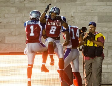 Montreal's Arland Bruce (left) celebrates teammate Brandon Whitaker's touchdown during the first half of the game between the Montreal Alouettes and the Edmonton Eskimos, at the Percival Molson Stadium in Montreal, QC, on July 25, 2013. The Eskimos lost 32-27 to the Alouettes. PIERRE-PAUL POULIN/LE JOURNAL DE MONTREAL/AGENCE QMI