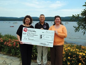 Gail Logan (left) and Shelley Rolland-Poruks (right) from the Renfrew County United Way present Mike Ueltzhoffer the chair of the Deep River and District Community Foundation with a cheque for $5,000. This is the first instalment of their $10,000 pledge to the foundation.