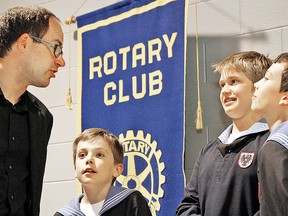 Choirmaster Oliver Stech, left, chats with Vienna Boys Choir members Adam, 10, Bastian, 12, and Christoph, 12, after a presentation to the Rotary Club of Stratford Thursday. The world-famous choir is scheduled to perform Friday, Saturday and Sunday at St. Andrew's Church as part of Stratford Summer Music. MIKE BEITZ The Beacon Herald