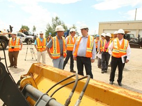 Infrastructure and Transportation Minister Glen Murray tours the patrol yard Friday on Golf Club Road where Transfield Services, which is contracted to do road maintenance in the area, stores its vehicles and equipment.