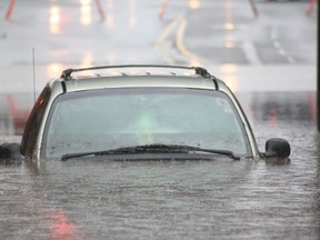 A minivan sits partially submerged in the Wellington Street underpass on Friday.