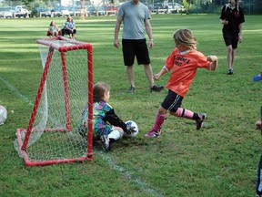 Bronwyn Kenny (orange team) takes a mighty kick to try and score on Adriana Silver at a soccer game during Shady Nook’s summer soccer program. For more community photos please visit our website photo gallery at www.thedailyobserver.ca.