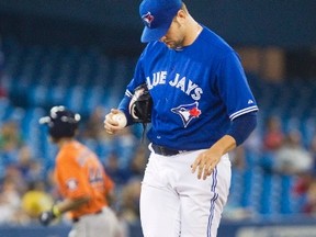 Toronto Blue Jays starting pitcher Josh Johnson kicks dirt on the mound after giving up a home run to Houston Astros Justin Maxwell rounding the bases behind him in the fourth inning of their American League MLB baseball game in Toronto July 27, 2013.  (REUTERS/Fred Thornhill)