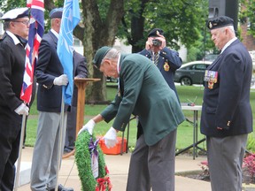 Korean War veteran Bill Oldale, left, places a memorial wreath with fellow vet Bill Lesperance at the Sarnia cenotaph Saturday. A sizable crowd of families and local dignitaries showed up for a special service to honour the 60th anniversary of the signing of the armistice that led to the end of the Korean War.