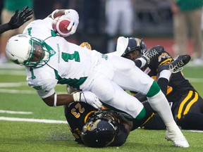 Tiger-Cats’ Brandon Isaac tackles Roughriders’ Kory Sheets in Guelph last night. It was Isaac’s first game with the Tabbies since being released by the Argonauts earlier this week. (Fred Thornhill/Reuters)