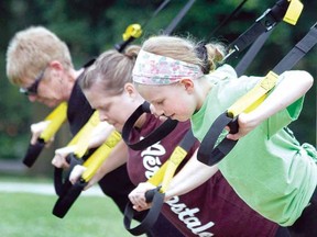 Ten-year-old Ainsley Robinson shows her mother Jen and grandmother Cathy how TRX suspension training is done during the Boot Camp for a Cause Saturday at the Central flats. Some 30 people took part in the unique fitness-oriented fundraiser for ALS, organized by Excel Fitness and Lifestyle Consultants. The event raised about $535 for the cause. (MIKE BEITZ The Beacon Herald)