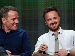 Cast member Bryan Cranston (left) smiles with co-star Aaron Paul at a panel for the television series "Breaking Bad" during the AMC portion of the Television Critics Association Summer press tour in Beverly Hills, Calif. July 26, 2013. (REUTERS/Mario Anzuoni)