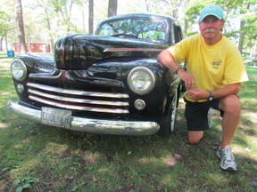 Mike Hudson kneels by his 1947 Ford Deluxe Coupe hot rod in the shade at Canatara Park. He will be back in the park, with other members of the Sarnia Street Machines, Aug. 1, 6 p.m. to 10 p.m., for its annual Hot August Nights car show. Car owners from the across the region are expected to participate in the event that raises money for Pathways Health Centre for Children. Sarnia, Ont., July 25, 2031 PAUL MORDEN/THE OBSERVER/QMI AGENCY