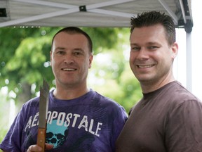 Rob Fawcett (right) stands beside the head chef at a barbeque/ car wash fundraiser in Ingersoll on Saturday in support of Fawcett's daughter Madison, who has a rare autoimmune disease. (CODI WILSON, Sentinel-Review)