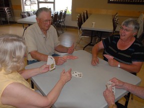 Seniors Lillian Haak, left to right, George Truhan, and Annis Sideroff indulge in a game of Whist while visiting the Golden Age Recreation Centre last Thursday. Participation in activities held at the centre such as card games, help seniors keep their minds and bodies active while socialising and making new friends, all factors that could help stave off signs of dementia. (Jocelyn Turner/Daily Herald-Tribune)