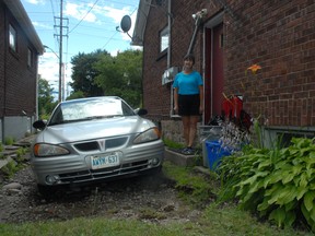 Sandra Rousseau surveys damage to her home on Wellington Street East.