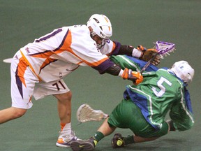 Chris George of the Arrows takes down Turner Evans of the Lakers on Sunday during Game 5 of their best-of-seven Ontario Junior A Lacrosse League semifinal series at the Iroquois Lacrosse Arena. (Darryl G. Smart, The Expositor)