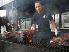 Ribs Royale owner Gus Sakellis flips some beef ribs during Cornwall’s Ribfest on Sunday.
Greg Peerenboom staff photo
