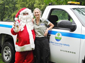 Santa Claus, along with Brant Park security officer Rachel Parasiuk, tours the campgrounds at the park on Saturday during the annual Christmas in July event. (Heather Ibbotson, The Expositor)