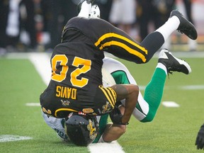 Tiger-Cats defensive back Emanuel Davis makes the tackle on Riders receiver Rob Bagg Saturday night in Guelph. Hamilton took another Saskatchewan beating, losing 32-20. (REUTERS)