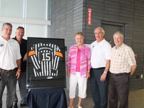 Central Hockey League official Steve Cruickshank, left, gets some help unveiling his referee sweater from friend Andy Attleberry, his mother Marie, CHL referee-in-chief Bryan Lewis and Brant Mayor Ron Eddy to honour his 1,000 games with the CHL in the U.S. during a sweater ceremony at the Brant Sports Complex on Thursday, July 18, 2013. MICHAEL PEELING/The Paris Star/QMI Agency