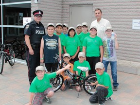 Timmins Police Constable David Ainsworth, left, and Tim Hortons franchisee Rob Knox were pleased to give out brand new bikes to a group of Timmins youngsters recently. Timmins Times LOCAL NEWS photo by Len Gillis.