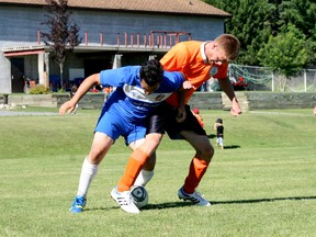 Dustin Boucha of the Kenora Centuries (right) tries to wrestle the ball away from a Brandon DoubleDecker player during overtime of the Kenora Men’s league Soccer Tournament championship game. The Brandon team ultimately defeated the Kenora team 1-0 to claim the 2013 champions title.
GRACE PROTOPAPAS/KENORA DAILY MINER AND NEWS