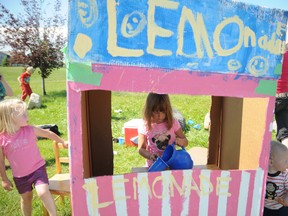 Airianna Bayne, 3, pours a cup of lemonade at her and her friends lemonade stand in the Crystal Lake area in Grande Prairie, Alberta, Monday, July 8, 2013. Bayne and her friends are trying to raise enough money to go to the movies. August 10 is  Lemonade Freedom Day; a day where people all over North America are encouraged to set up a lemonade stand. AARON HINKS/DAILY HERALD-TRIBUNE