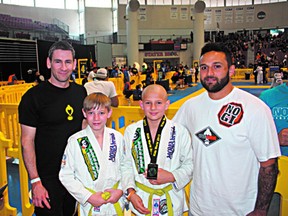 Sherwood Park Arashi Do members Owen Kucy (second from left) and David Elliot (second from right) pose with coaches after capturing medals at the recent Kid’s Brazilian Jiu Jitsu World Championships in California. Photo supplied
