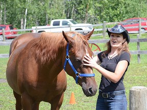 Dreamcatcher nature-assisted therapy founder Eileen Bona rubs one of her horse’s nose during a demonstration at Dreamcatcher’s open house on Wednesday, July 24. Steven Wagers/Sherwood Park News/QMI Agency